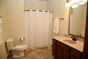 Aberdeen apartment for rent - A bathroom with a toilet, sink, and shower curtain.
