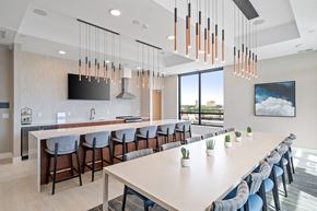 Minnetonka apartment for rent - a room with a long table and chairs and a large window