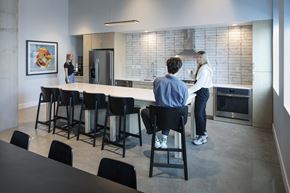 Minneapolis apartment for rent - a man and a woman standing at a counter in a kitchen
