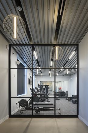 Minneapolis apartment for rent - a view of a gym with weights machines and a large glass window