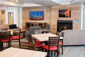 Minneapolis apartment for rent - a dining room with tables and chairs and a fireplace