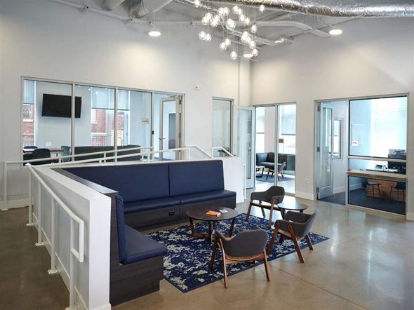 St. Paul apartment for rent - a large room with a blue couch and chairs