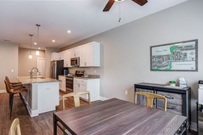 Wyoming apartment for rent - A modern kitchen with a wooden table and chairs.