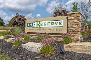 Wyoming apartment for rent - A sign for "The Reserve Apartments & Single Family Homes" is displayed in front of a landscaped area.