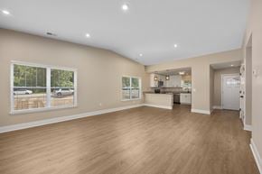Williamsburg apartment for rent - A spacious room with wooden flooring and a large window.