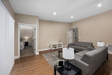 Williamsburg apartment for rent - A living room with a grey couch and a black coffee table.