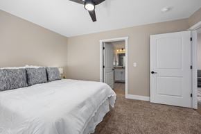 Williamsburg apartment for rent - A bedroom with a white bed and a ceiling fan.