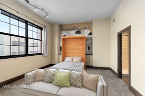 Grand Rapids apartment for rent - A bedroom with a large bed and a window with blinds.