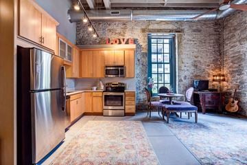 Grand Rapids apartment for rent - a kitchen with wooden cabinets and stainless steel appliances in a loft