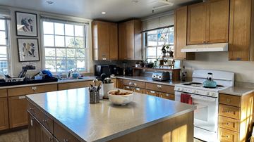 San Francisco apartment for rent - A kitchen with a large island in the middle and wooden cabinets.