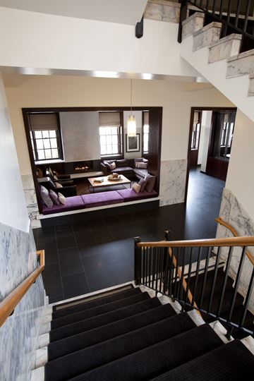 San Francisco townhouse for rent - A staircase with a black carpeted runner leads to a living room with a couch and a coffee table.