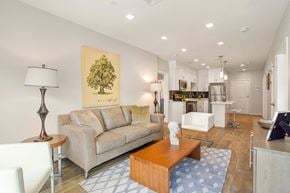 Cambridge apartment for rent - a living room with a couch and a coffee table in front of a kitchen