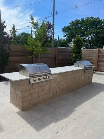 Middlesex apartment for rent - a brick outdoor kitchen with two grills in a backyard