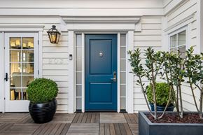 Pacific Palisades apartment for rent - A white house with a blue door and a black planter.