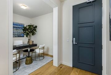 Los Angeles apartment for rent - a living room with a blue door and a table and chairs