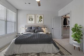 Colorado Springs apartment for rent - A bedroom with a large bed and a ceiling fan.