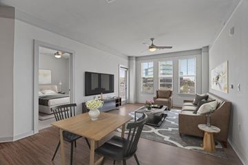 Colorado Springs apartment for rent - A modern living room with a wooden table and black chairs.