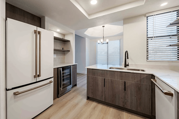 Scottsdale apartment for rent - A modern kitchen with a white refrigerator and wooden cabinets.