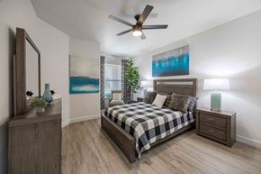 Henderson apartment for rent - a bedroom with a bed and a ceiling fan