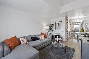 Henderson townhouse for rent - a living room with a gray couch and a glass coffee table