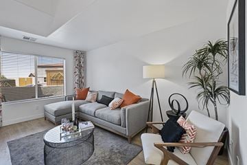 Henderson townhouse for rent - a living room with couches and a table and a large window