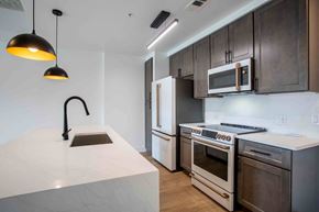 Nashville apartment for rent - a kitchen with wooden cabinets and a white counter top