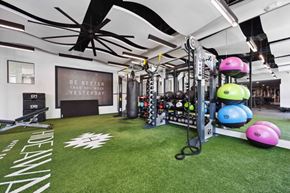 Scottsdale apartment for rent - A gym with a green floor and a sign that says "Be better than you were yesterday".