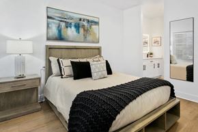 Scottsdale apartment for rent - A bedroom with a large bed and a painting on the wall.