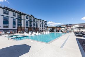 Colorado Springs apartment for rent - Pool with a sun deck and cabanas with the backdrop of Jasper at Victory Ridge's brand new apartments in Colorado Springs.