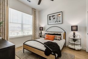 Colorado Springs apartment for rent - an apartment bedroom with a bed and a large window