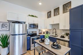 Colorado Springs apartment for rent - Contemporary kitchen featuring stainless steel appliances at Jasper at Victory Ridge luxury apartments Colorado Springs.