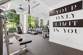 Charlotte apartment for rent - a gym with cardio equipment and a large sign that says your only limit is you