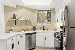 Tempe apartment for rent - A kitchen with white cabinets and a stainless steel refrigerator.