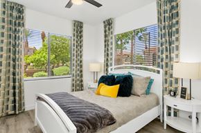 Tempe apartment for rent - A bedroom with a bed, nightstand, and window with curtains.