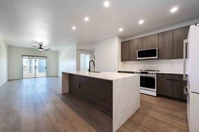 Phoenix apartment for rent - a kitchen with brown cabinets and stainless steel appliances at Slate Scottsdale, lofts for rent Phoenix.