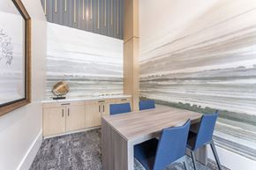 San Diego apartment for rent - A conference room with a wooden table and blue chairs.