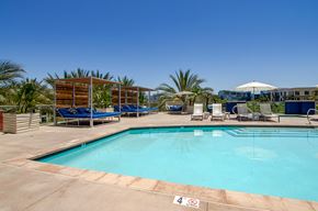 San Diego apartment for rent - a resort style pool with lounge chairs and umbrellas