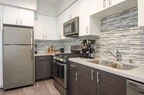 San Diego apartment for rent - a kitchen with white cabinets and stainless steel appliances