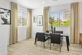 Glendale apartment for rent - a dining room with a table and chairs and windows with yellow curtains