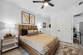 Glendale apartment for rent - A bright bedroom with modern decor and sign features at Zone Westgate, apartments in Glendale, AZ.