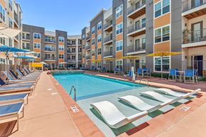 Centennial apartment for rent - A swimming pool surrounded by sun loungers and apartment buildings.