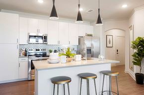 Castle Rock apartment for rent - A kitchen with a white counter and bar stools.