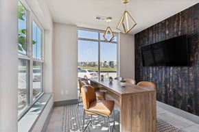 Castle Rock apartment for rent - A modern dining area with a wooden table and chairs.