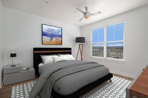 Castle Rock apartment for rent - A bedroom with a large bed and a painting on the wall.