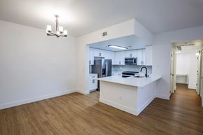 Henderson apartment for rent - A kitchen with white cabinets and a wooden floor.