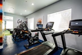Henderson apartment for rent - A gym with a treadmill, exercise bike, and rowing machine.