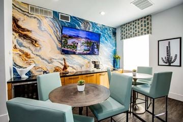 Henderson apartment for rent - A living room with a table and chairs and a TV on the wall.