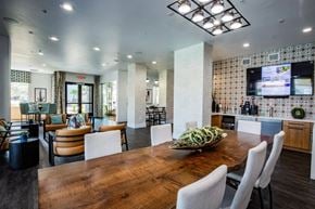 Henderson apartment for rent - A modern dining room with a wooden table and chairs.