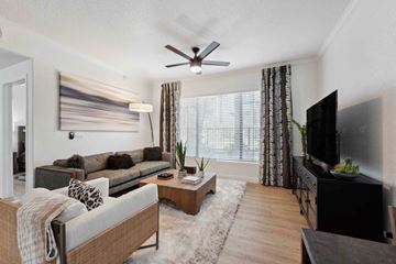 Chandler apartment for rent - A living room with a grey couch and a wooden coffee table.