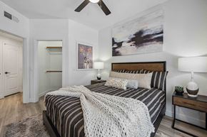 Chandler apartment for rent - A bedroom with a bed, two lamps, and a painting on the wall.